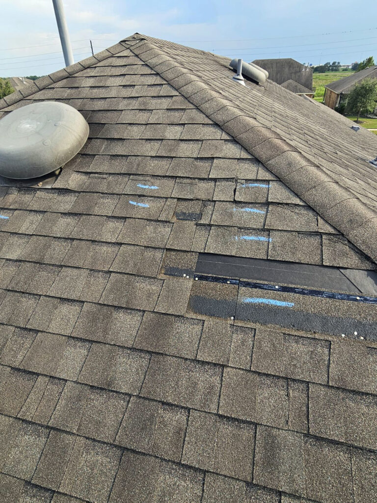 roof damage with missing and creased shingles in Katy TX